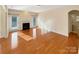 Spacious living room featuring gleaming hardwood floors and a cozy fireplace at 9503 Rocky Spring Nw Ct, Concord, NC 28027