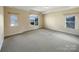 Bright main bedroom with large windows and neutral carpet flooring at 9503 Rocky Spring Nw Ct, Concord, NC 28027