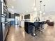 Modern kitchen featuring stainless steel appliances, a large island with seating, and stylish dark cabinetry at 9677 Garamont Nw Pkwy, Concord, NC 28027