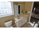 Bathroom with a large mirror, white cabinets, and a view into the adjacent bedroom at 1013 Mays Ct, Gastonia, NC 28054