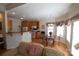 Cozy living room featuring hardwood floors, an adjacent kitchen, and a sunny dining nook at 1013 Mays Ct, Gastonia, NC 28054