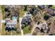Aerial view of a home featuring a swimming pool, manicured yard, and mature trees at 10207 Rattersly Ct, Charlotte, NC 28277