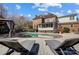 Stunning backyard with an in-ground pool, lounge chairs, and manicured landscaping at 10207 Rattersly Ct, Charlotte, NC 28277