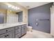 Bathroom featuring a dual sink vanity, a large mirror, and a shower and tub combo at 10207 Rattersly Ct, Charlotte, NC 28277