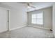 Neutral bedroom featuring a ceiling fan, carpet flooring, and a closet at 10207 Rattersly Ct, Charlotte, NC 28277