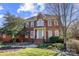 Charming two-story brick home with well-manicured landscaping and a welcoming light-blue front door at 10207 Rattersly Ct, Charlotte, NC 28277