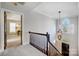 Elegant foyer with a hanging light fixture, staircase and large arched window for natural lighting at 10207 Rattersly Ct, Charlotte, NC 28277