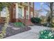 Close-up of a brick staircase leading up to a light-blue front door with well-maintained landscaping at 10207 Rattersly Ct, Charlotte, NC 28277