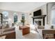 Bright living room with fireplace, large windows, hardwood floors, and stylish furnishings at 10207 Rattersly Ct, Charlotte, NC 28277