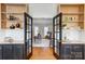 Bright home office featuring a wooden desk, natural light, hardwood floors, and a comfortable sitting area at 10207 Rattersly Ct, Charlotte, NC 28277