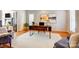 Bright home office featuring a wooden desk, natural light, hardwood floors, and a comfortable sitting area at 10207 Rattersly Ct, Charlotte, NC 28277