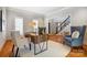Bright home office featuring a wooden desk, natural light, hardwood floors, and a comfortable sitting area at 10207 Rattersly Ct, Charlotte, NC 28277