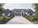 Stunning exterior view of a two-story home with a stone driveway and manicured landscaping at 1025 Maxwell Ct # 7, Marvin, NC 28173