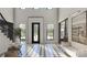 Bright foyer featuring checkerboard tile, staircase with black iron railing, and an abundance of natural light at 1025 Maxwell Ct # 7, Marvin, NC 28173