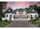 Stunning two-story home featuring elegant white brick, grand entrance, and meticulously landscaped front yard and driveway at 1045 Maxwell Ct # 10, Marvin, NC 28173
