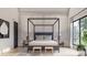 Elegant bedroom with a four-poster bed, stylish decor, and natural light from a large window at 1057 Maxwell Ct # 13, Marvin, NC 28173