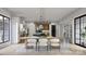A spacious dining room featuring contemporary lighting, large windows, and modern decor at 1057 Maxwell Ct # 13, Marvin, NC 28173