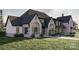 Gorgeous stone and dark trim accentuates this spacious single Gathering home with well manicured landscaping and a lush lawn at 1057 Maxwell Ct # 13, Marvin, NC 28173