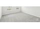 A well-lit bedroom with plush carpeting and a serene atmosphere at 114 Ciara Pl # A, Mooresville, NC 28117