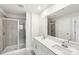 Bathroom showcasing dual sinks, white cabinets, a large mirror, and a glass shower at 114 Ciara Pl # B, Mooresville, NC 28117