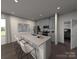 Modern kitchen with stainless steel appliances, a central island with bar stools and gray cabinetry at 114 Ciara Pl # C, Mooresville, NC 28117