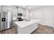 Stylish kitchen features white cabinetry, stainless steel appliances, and a center island with seating at 114 Ciara Pl # C, Mooresville, NC 28117