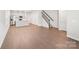 Open-concept living area with hardwood floors, staircase, and abundant natural light at 114 Ciara Pl # C, Mooresville, NC 28117