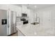 Open kitchen featuring stainless steel appliances, white cabinetry, and granite countertops on the center island at 114 Ciara Pl # E, Mooresville, NC 28117