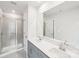 Modern bathroom featuring double sinks, a large mirror, and a glass-enclosed shower at 114 Ciara Pl # F, Mooresville, NC 28117