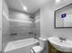 Updated bathroom featuring tiled shower-tub, modern sink, and sleek gray tile at 118 W Lee Ave, Bessemer City, NC 28016