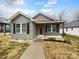 Charming single-story home featuring board and batten siding, black shutters, and covered front porch at 118 W Lee Ave, Bessemer City, NC 28016