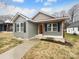 Charming single-story home featuring board and batten siding, black shutters, and covered front porch at 118 W Lee Ave, Bessemer City, NC 28016