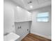 Functional laundry room with sink, storage cabinets, and washer/dryer hookups at 118 W Lee Ave, Bessemer City, NC 28016