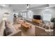 Staged living room showcasing the open floor plan with hardwood floors and tray ceiling at 118 W Lee Ave, Bessemer City, NC 28016