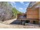 View of a wooden deck overlooking the spacious backyard, surrounded by mature trees, offering a private outdoor space at 121 Inlet Point Dr, Tega Cay, SC 29708