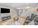 Finished basement with home theater seating, wood-look floors, and ample lighting at 121 Inlet Point Dr, Tega Cay, SC 29708
