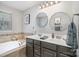 Inviting bathroom with double sinks, a soaking tub, and elegant decor at 121 Inlet Point Dr, Tega Cay, SC 29708