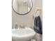 Elegant powder room featuring a modern sink, stylish mirror, and contemporary fixtures at 121 Inlet Point Dr, Tega Cay, SC 29708