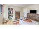 Bedroom featuring a well-organized closet, wood-look floors, and neutral decor at 121 Inlet Point Dr, Fort Mill, SC 29708