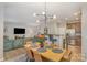 Open-concept dining area with modern lighting, seamlessly connected to living room and kitchen at 121 Inlet Point Dr, Tega Cay, SC 29708