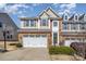 Charming townhome with stone accents, a two-car garage, and a well-maintained lawn in a desirable neighborhood at 121 Inlet Point Dr, Tega Cay, SC 29708