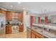 Well-equipped kitchen with stainless steel appliances, granite countertops, and wooden cabinets at 121 Inlet Point Dr, Tega Cay, SC 29708