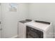 Efficient laundry room with modern, front-load washing machine and dryer at 121 Inlet Point Dr, Tega Cay, SC 29708