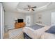 Spacious main bedroom with a tray ceiling, dresser, vanity, and modern decor at 121 Inlet Point Dr, Tega Cay, SC 29708