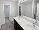 Well-lit bathroom featuring double sinks and a walk-in closet at 121 Woodbridge Cir, Mount Holly, NC 28120