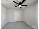 Neutral bedroom features soft carpet, a ceiling fan, and a closet at 121 Woodbridge Cir, Mount Holly, NC 28120