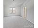 Bedroom has soft neutral carpeting and natural light from a window at 121 Woodbridge Cir, Mount Holly, NC 28120