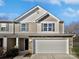 Charming two-story home with a stone-accented facade and a two-car garage at 121 Woodbridge Cir, Mount Holly, NC 28120