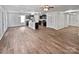 Spacious living room boasts wood-style flooring, with easy access to the kitchen and a ceiling fan at 121 Woodbridge Cir, Mount Holly, NC 28120