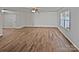 Bright living room with wood-look flooring, a ceiling fan, and a large window at 121 Woodbridge Cir, Mount Holly, NC 28120